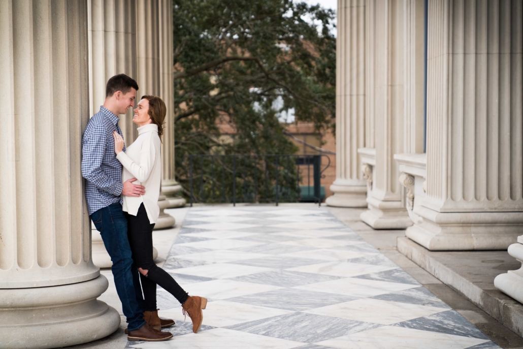 Engaged couple kisses outside a courthouse
