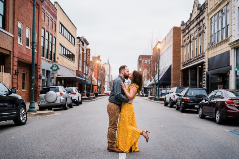 Engaged couple poses in the street Johnson City Tennessee